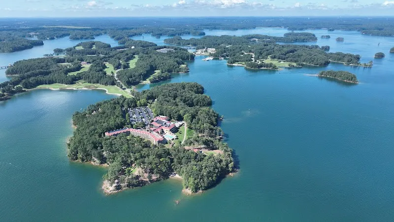 Aerial view of Lake Lanier resort on forested peninsula with surrounding islands.