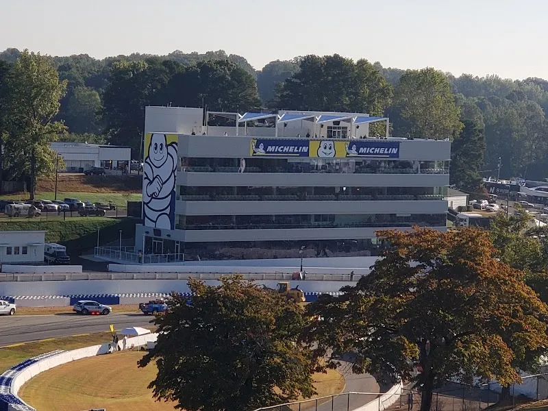 Michelin tower building overlooking racetrack with Bibendum mascot and branded signage